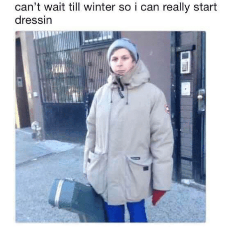 a photo of michael cera in a huge coat with the caption 'can't wait till winter so i can really start dressin'